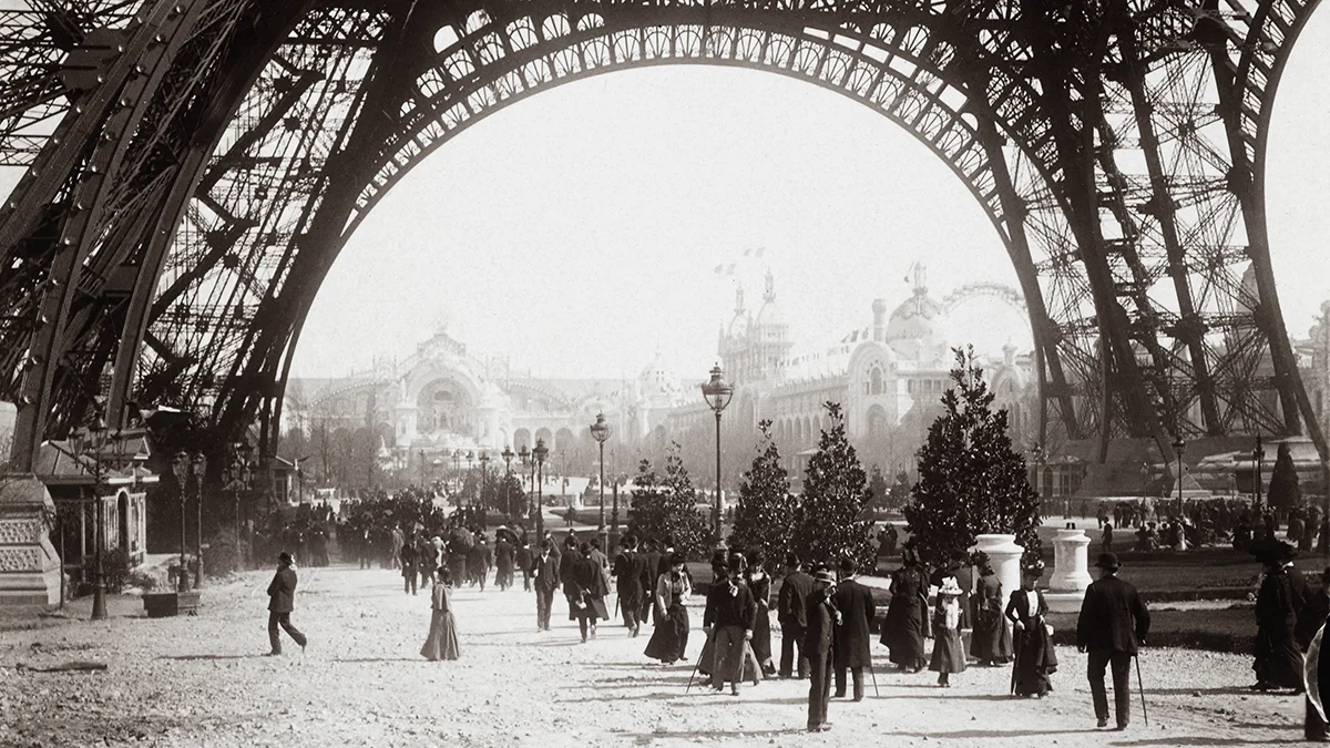 vintage social photograph below Eiffel Tower, circa 1900